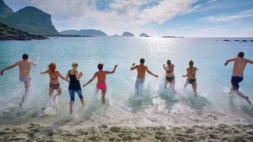 8-persone-maschi-e-femmine-in-fila-che.-corrono-per-buttarsi-in-mare